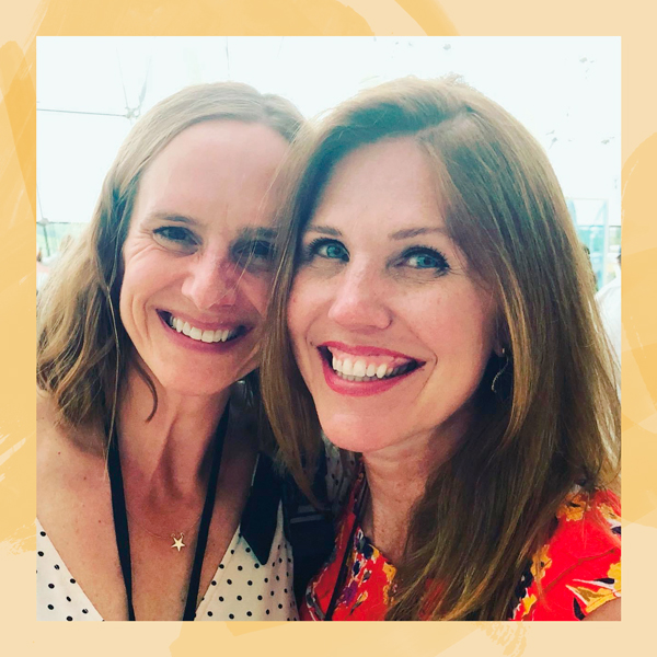 Two women smiling together.