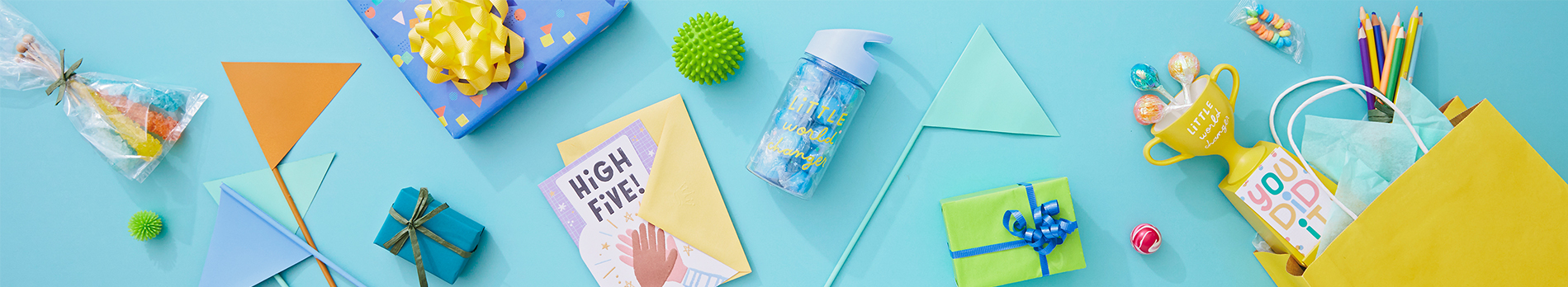 A variety of wrapped or bagged gifts lying on a bright aqua background.